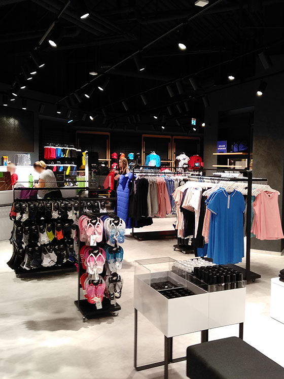 Clothing rails, accessory displays and product tables in a retail interior
