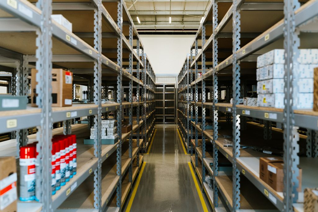 Rows of storage shelving holding cartons and packaged stock