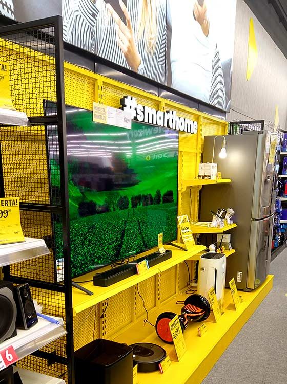 Yellow retail display zone with shelves and a large graphic panel
