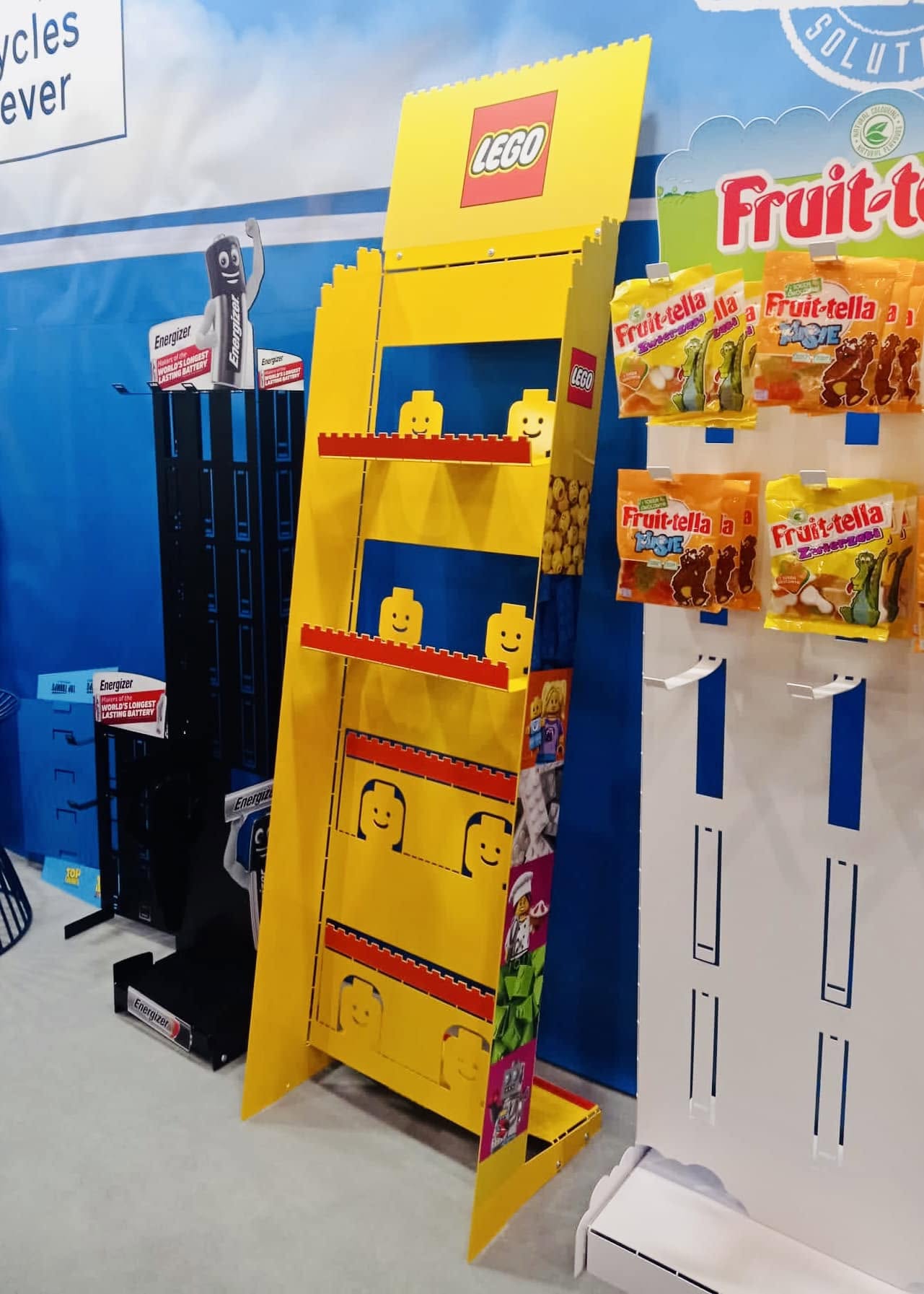 Freestanding POS stands with product hooks, shelves and branded header panels