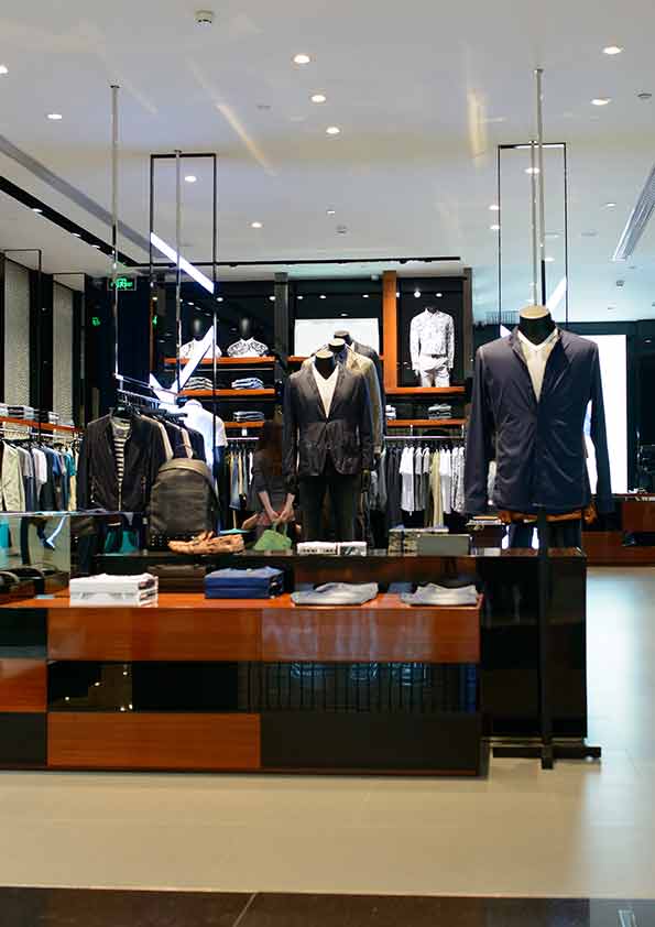 Product presentation table with surrounding clothing fixtures