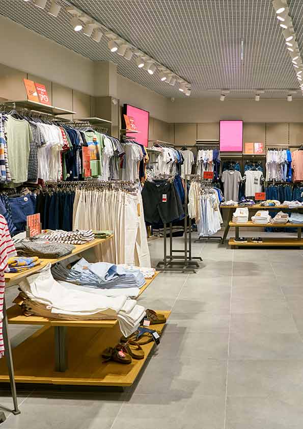 Clothing display tables and hanging rails in a retail interior