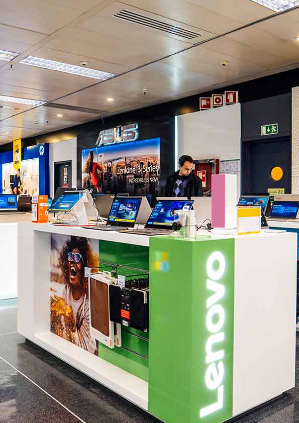 Retail product presentation counter displaying electronic devices