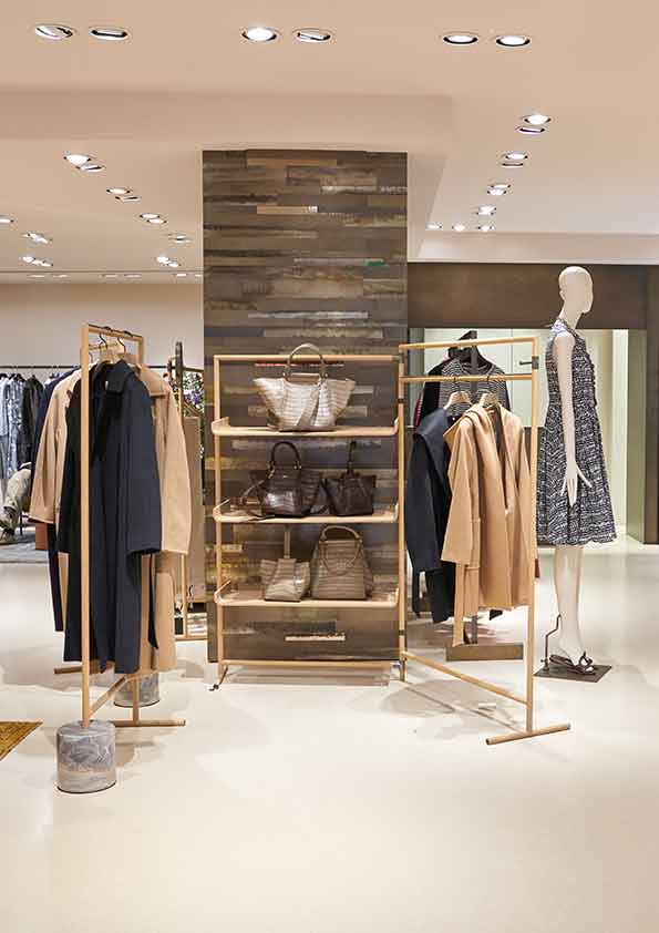 Clothing rails and wall shelves around a central display
